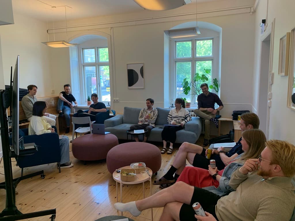 A group of Swace colleagues sitting together in the office lounge, having an informal meeting and discussion.