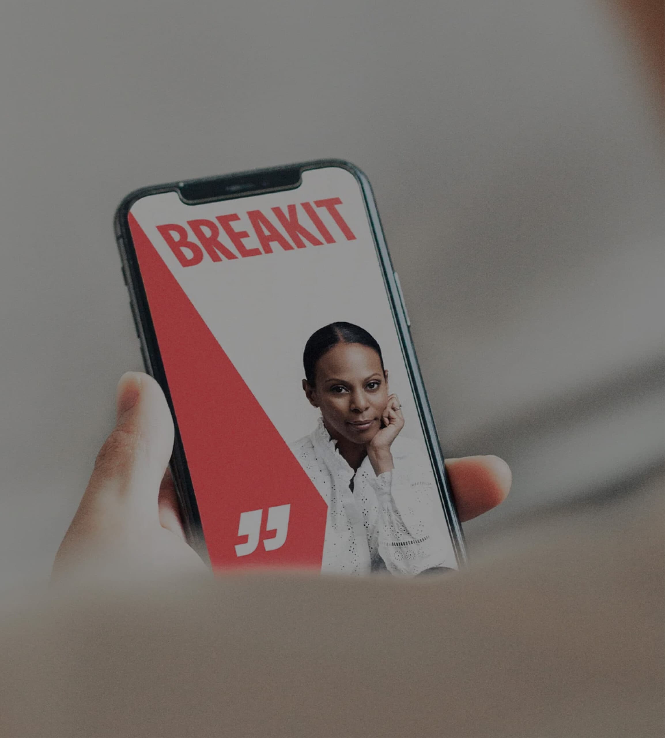 A person reads an article on Breakit featuring a confident woman in a white blouse, displayed prominently on a mobile screen