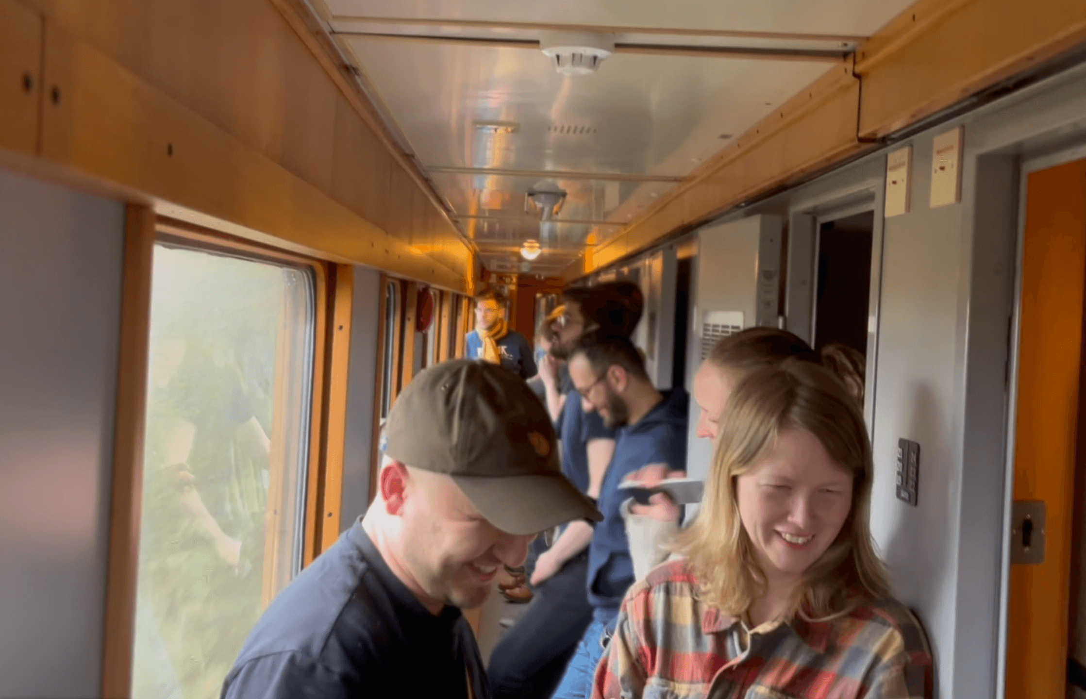 Swace colleagues standing and chatting in the train corridor on their way to Åre, early in the morning.